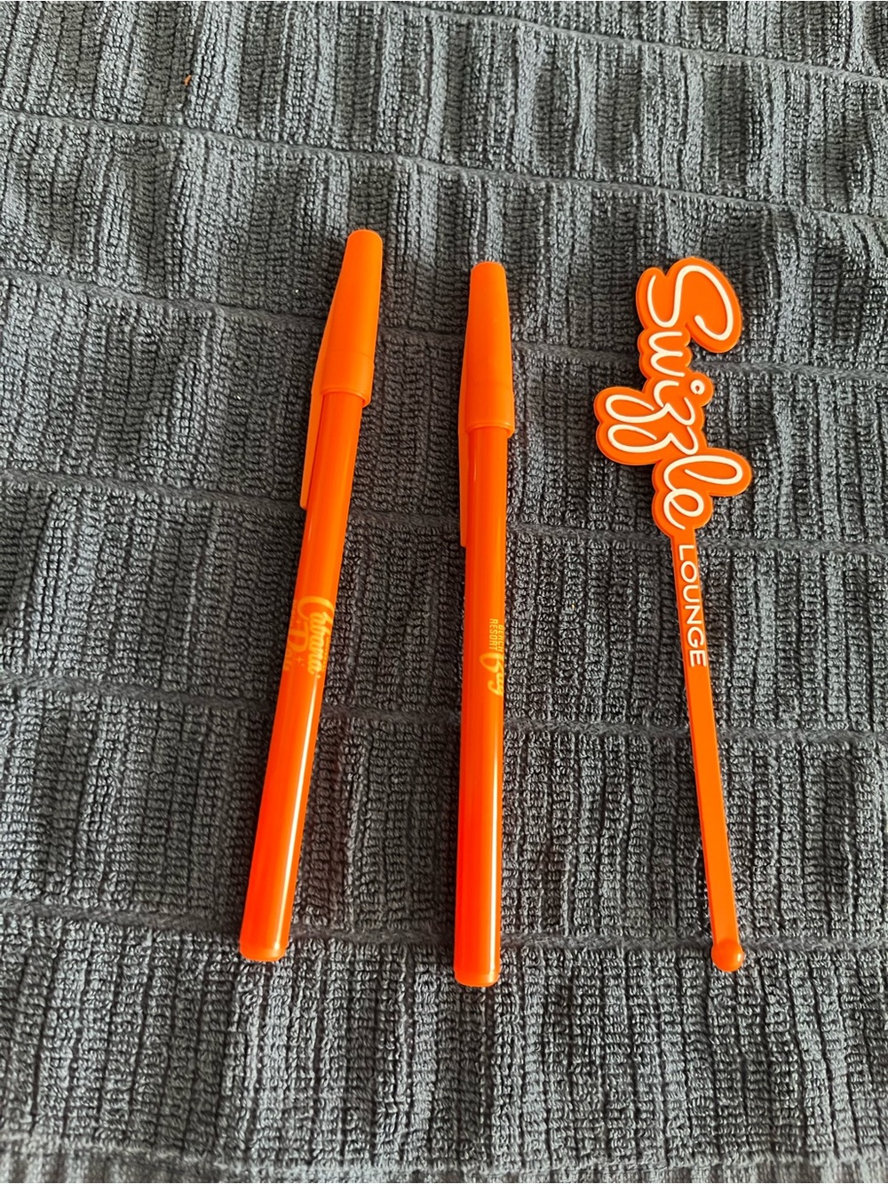 One Orange Drink Swizzle stick drink Stirrers and two Cabana Bay pens